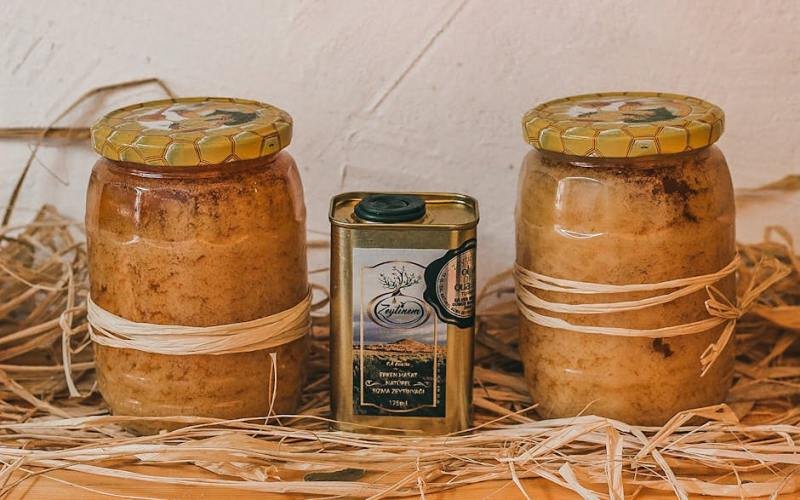 Homemade honey jars and olive oil can in a rustic setup. Perfect for organic food themes.